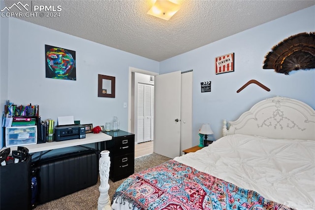 carpeted bedroom featuring a textured ceiling