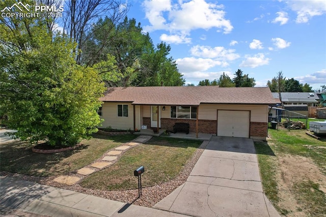 ranch-style home with a front yard and a garage