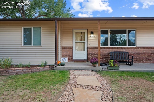 doorway to property featuring covered porch