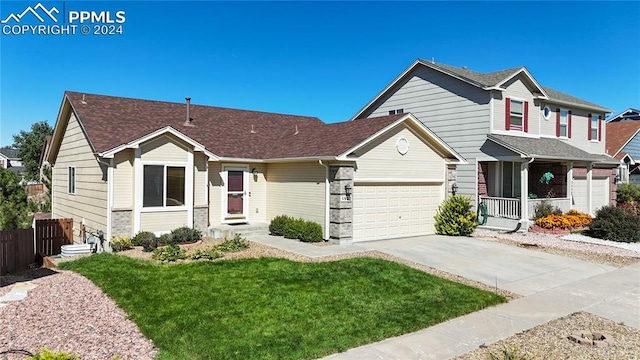 view of front of home with a garage, covered porch, and a front yard