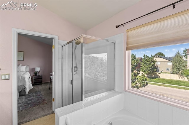 bathroom with plus walk in shower, plenty of natural light, and lofted ceiling