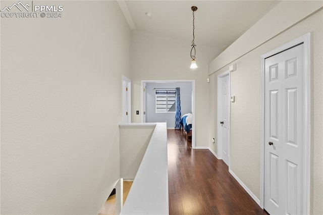 hallway featuring dark hardwood / wood-style floors and vaulted ceiling