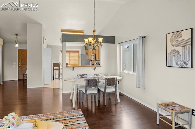 dining space featuring an inviting chandelier, vaulted ceiling, and dark wood-type flooring