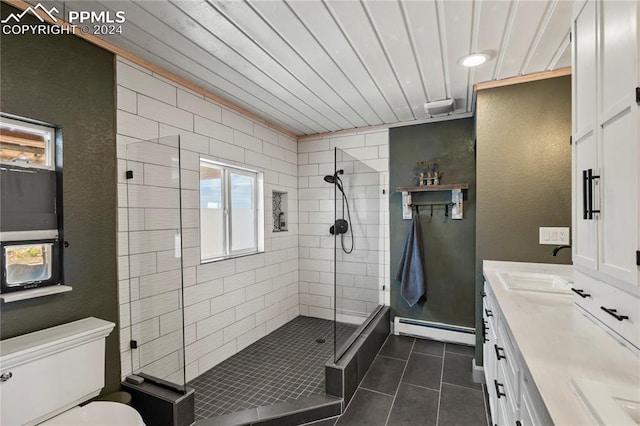 bathroom featuring vanity, a shower with door, toilet, a baseboard heating unit, and tile patterned floors