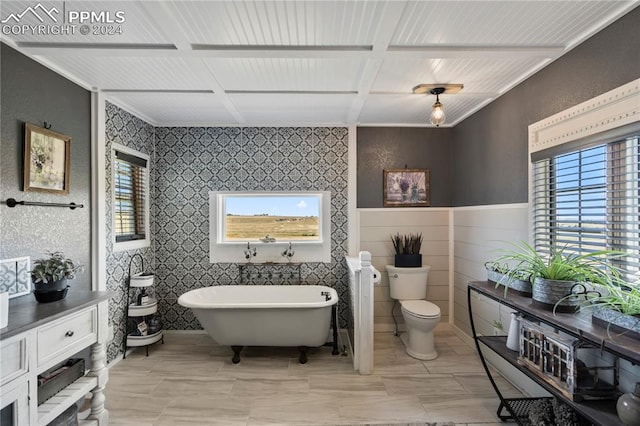 bathroom with vanity, a bath, coffered ceiling, tile walls, and toilet