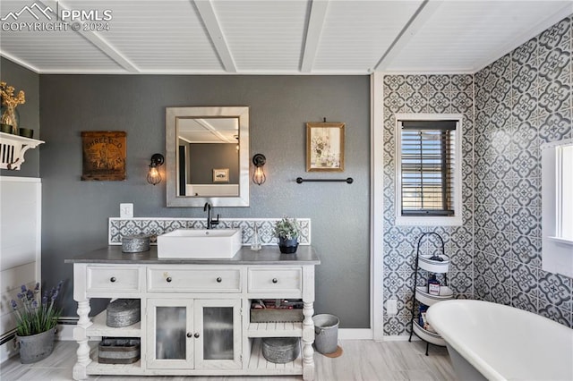 bathroom with vanity, a bathtub, and a baseboard radiator