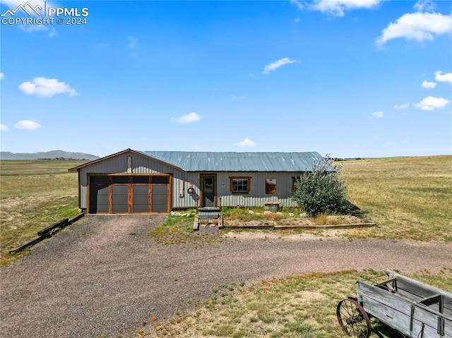 view of front facade featuring a mountain view, a rural view, and a garage