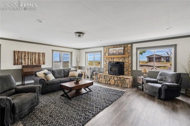 living room featuring ornamental molding, wood-type flooring, plenty of natural light, and a fireplace