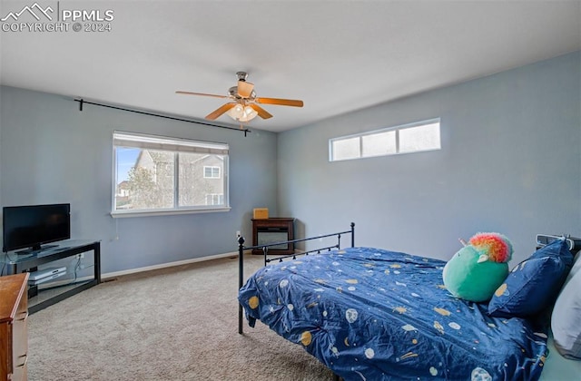 bedroom with carpet flooring, multiple windows, and ceiling fan