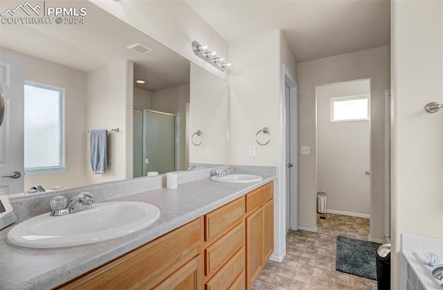 bathroom featuring separate shower and tub and vanity