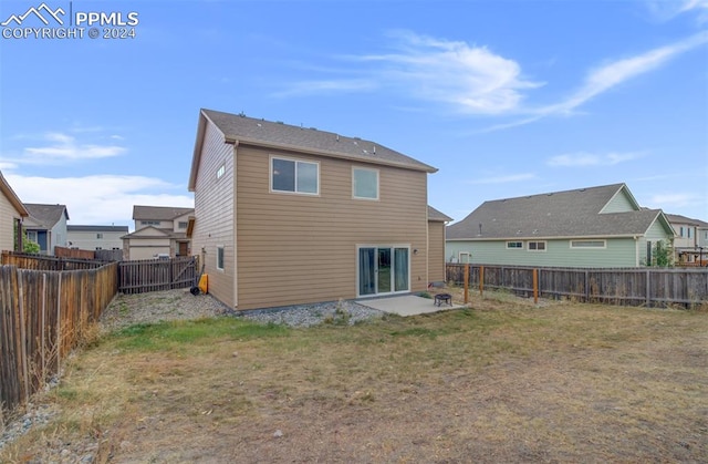 rear view of house featuring a patio and a lawn