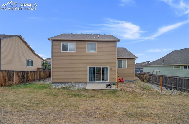 rear view of property with a lawn and a patio area