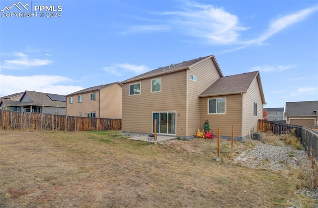 rear view of property featuring a yard