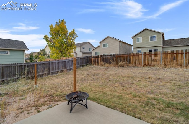 view of yard with an outdoor fire pit and a patio