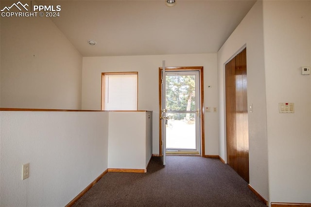 entryway with dark carpet