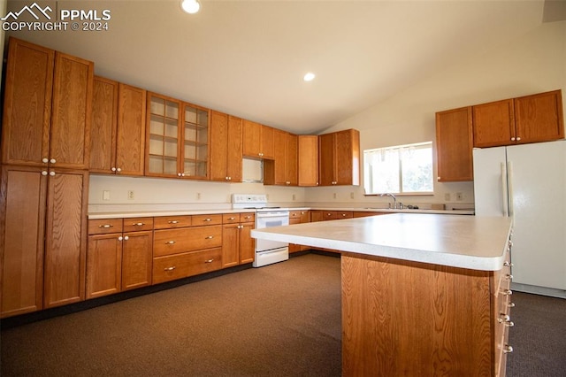 kitchen featuring sink, vaulted ceiling, dark colored carpet, and white appliances