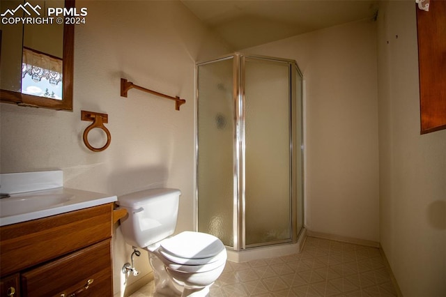 bathroom featuring vanity, tile patterned flooring, toilet, and an enclosed shower