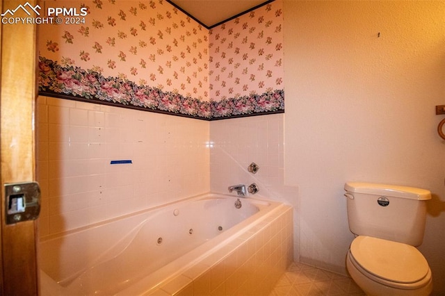 bathroom featuring toilet and a relaxing tiled tub