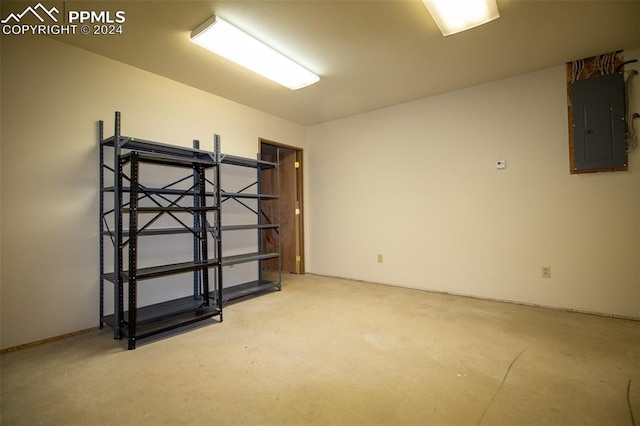 empty room with concrete floors and electric panel