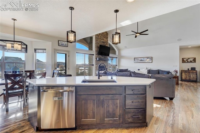 kitchen featuring a kitchen island with sink, dishwasher, light hardwood / wood-style floors, and sink