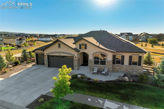 view of front of home with a front lawn and a garage