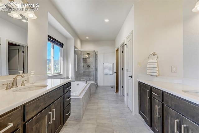 bathroom with tile patterned flooring, shower with separate bathtub, and vanity