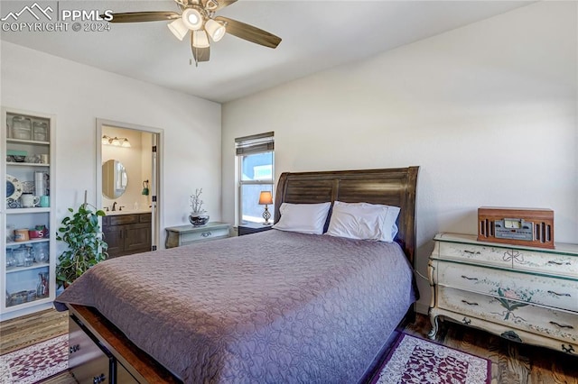 bedroom with dark hardwood / wood-style floors, ceiling fan, sink, and ensuite bath