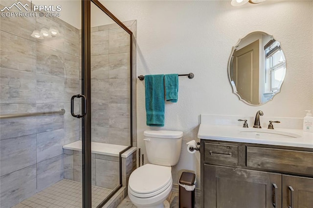 bathroom featuring toilet, vanity, and walk in shower