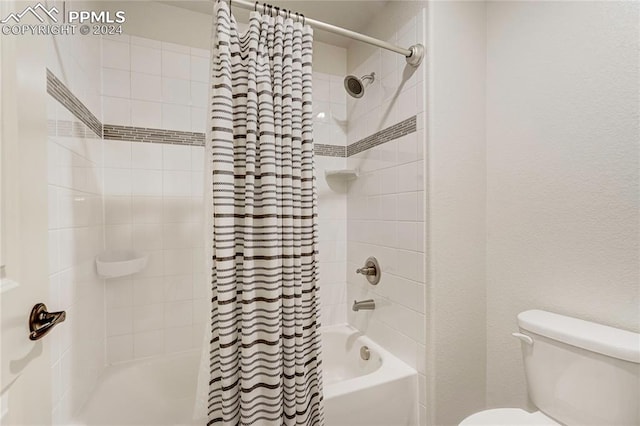 bathroom with shower / bath combo and toilet