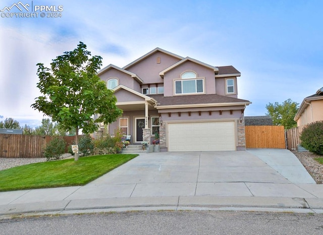 view of front facade featuring a garage and a front lawn