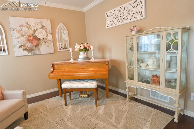 sitting room featuring wood-type flooring and crown molding