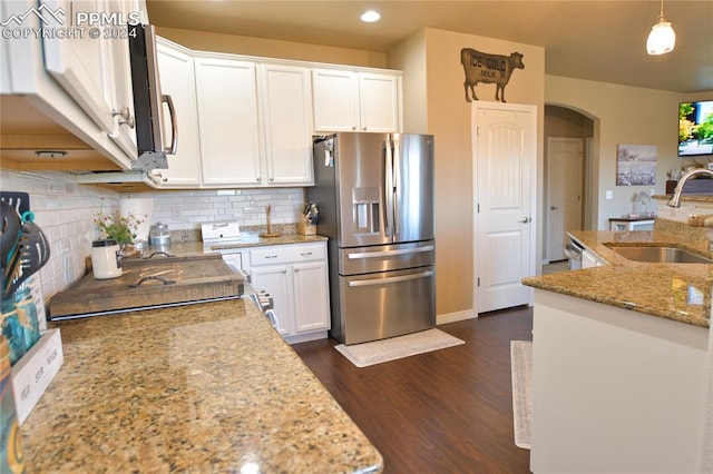 kitchen featuring light stone counters, white cabinets, pendant lighting, sink, and appliances with stainless steel finishes