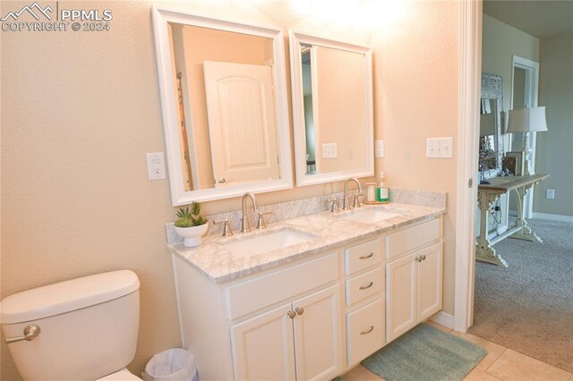 bathroom with vanity, toilet, and tile patterned floors