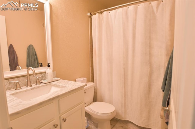 bathroom featuring vanity, toilet, and a shower with shower curtain