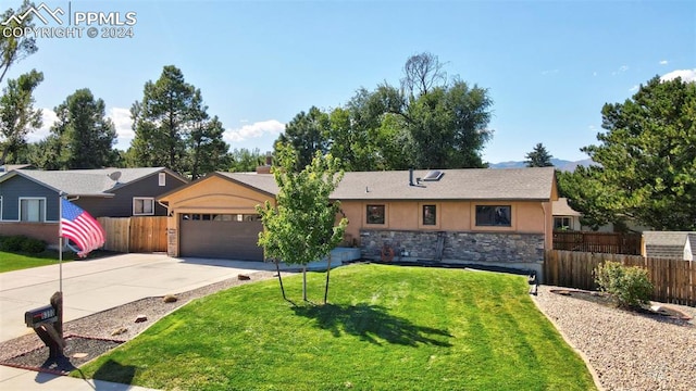 single story home featuring a garage and a front yard