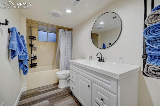 full bathroom featuring vanity, toilet, shower / bath combo with shower curtain, and hardwood / wood-style flooring