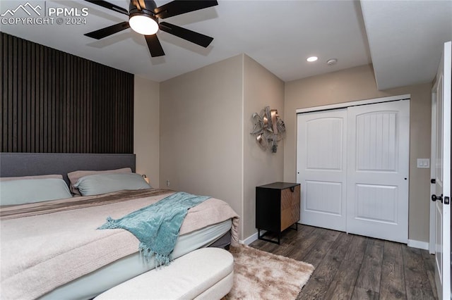 bedroom featuring ceiling fan, dark wood-type flooring, and a closet