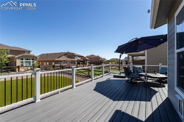 wooden terrace with a yard