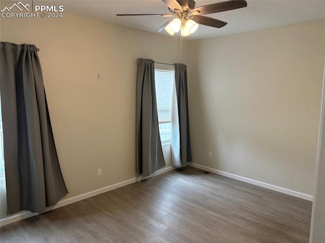 empty room featuring ceiling fan and hardwood / wood-style floors