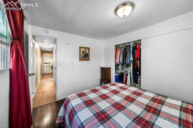 unfurnished bedroom featuring wood-type flooring, a closet, and a textured ceiling