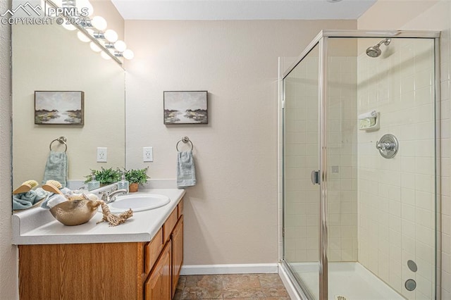 bathroom featuring vanity and a shower with shower door