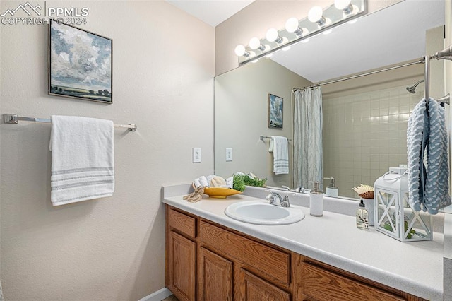 bathroom featuring vanity and a shower with shower curtain