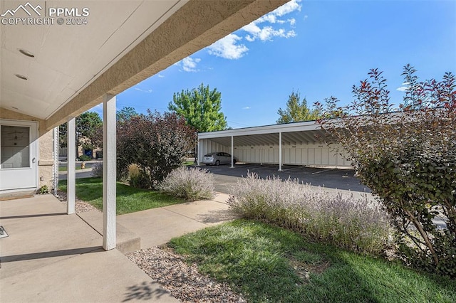 exterior space with a lawn and a carport