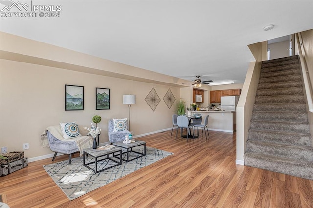 sitting room featuring ceiling fan and light wood-type flooring