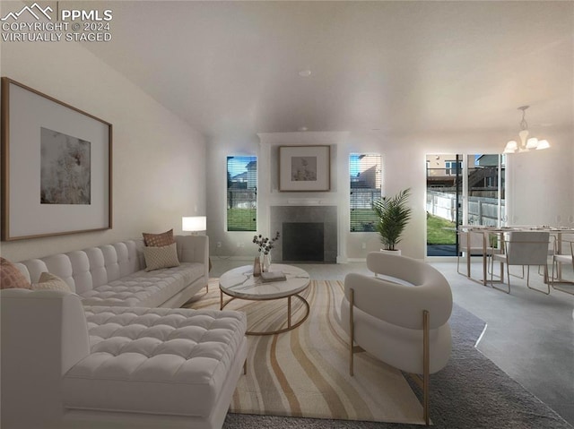 living room featuring a tile fireplace and a chandelier