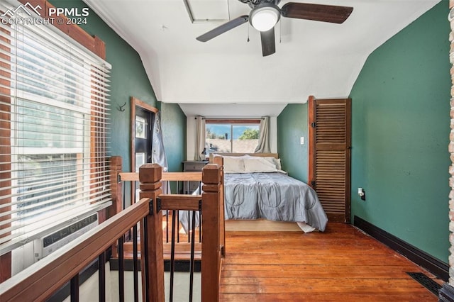 bedroom with vaulted ceiling, hardwood / wood-style floors, and ceiling fan