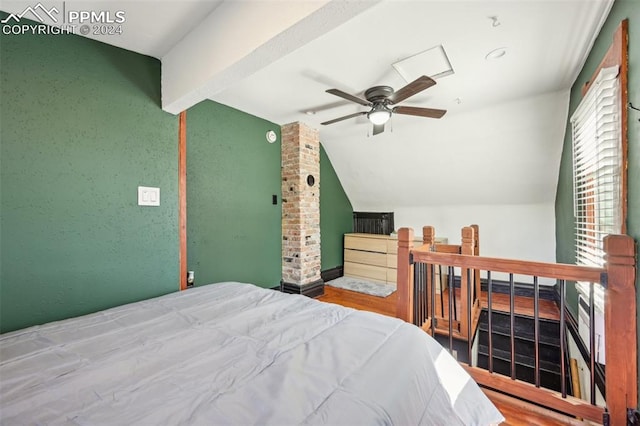 bedroom featuring ceiling fan, lofted ceiling, and wood-type flooring