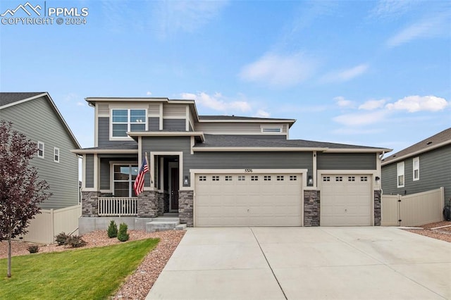 view of front of home with a front yard and a garage