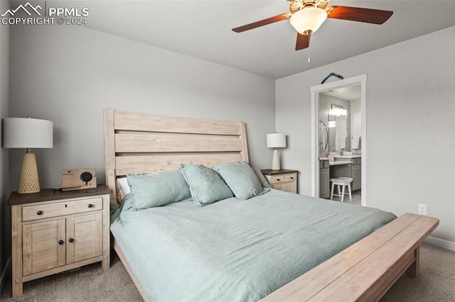 carpeted bedroom with ceiling fan and ensuite bath