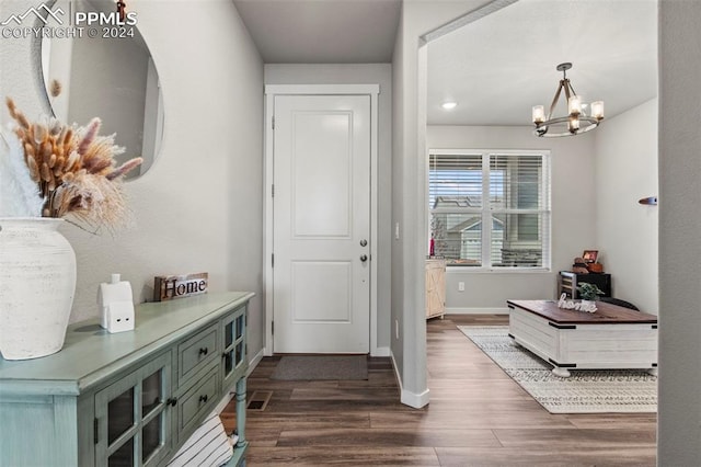 entrance foyer with a chandelier and dark hardwood / wood-style floors